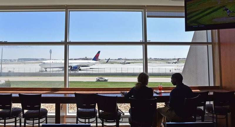 In this photo taken in August 2015, Vicki Van Der Hoek (left) and Leon Shields talk at the Renaissance Concourse Atlanta Airport Hotel. Vicki and Leon would often come to the bar watching planes. HYOSUB SHIN / HSHIN@AJC.COM