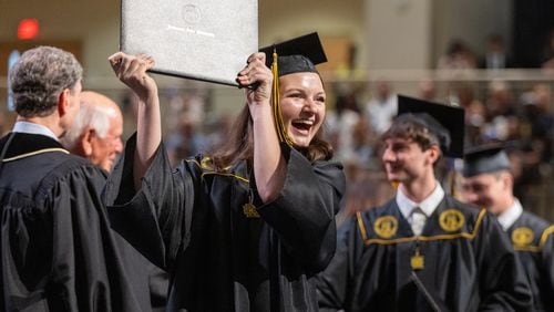 Rebecca Verlander reacts after receiving her diploma at Kennesaw State University on Tuesday, May 7, 2014.  (Steve Schaefer / AJC)