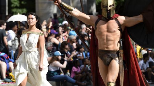 Cosplayers dressed as Queen Gorgo and King Leonidas I, left to right, walk down Peachtree Street at the annual Dragon Con Parade on  Saturday, Sept. 1, 2018, in Atlanta. (Photo: Jenna Eason / Jenna.Eason@coxinc.com)