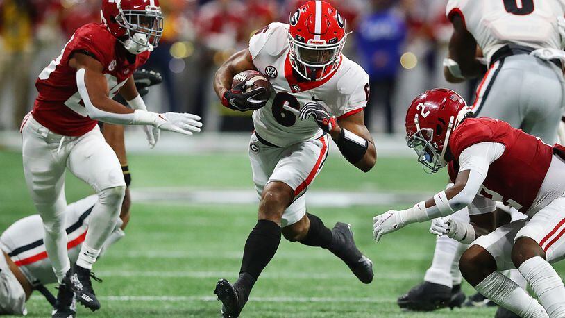 Georgia running back Kenny McIntosh finds some running room between Alabama defenders during the second half in the SEC Championship game on Dec 4 in Atlanta. (Curtis Compton / Curtis.Compton@ajc.com)