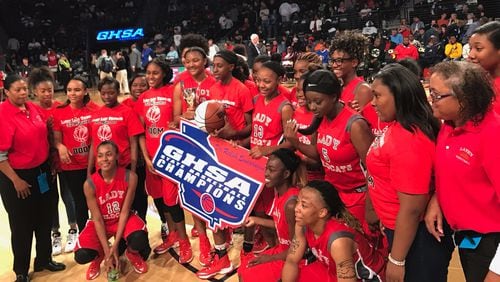 The Laney Lady Wildcats pose as De'Sha Benjamin holds the trophy following the Class AA championship win over Rabun County.