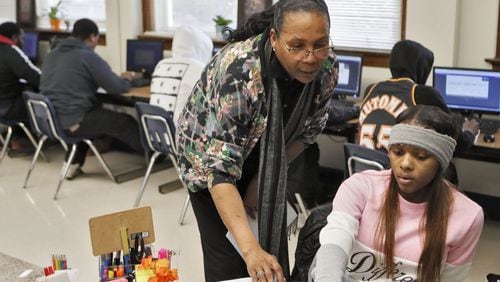 Phoenix Academy Principal Evelyn Mobley checks the progress dashboard of Tiana Mathis, 19, in a Nov. 12, 2019, social studies class, where the students work independently under a teacher’s supervision. Atlanta Public Schools merged its alternative high school programs into the Phoenix Academy, which launched this school year. The academy offers a food pantry, a nursery for children of students, and a clothing boutique, where students can get needed supplies and clothes to wear to job interviews. BOB ANDRES / ROBERT.ANDRES@AJC.COM