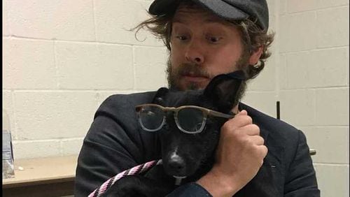Wesley Schultz of The Lumineers cuddles with a dog at the Georgia SCPA in Suwanee.