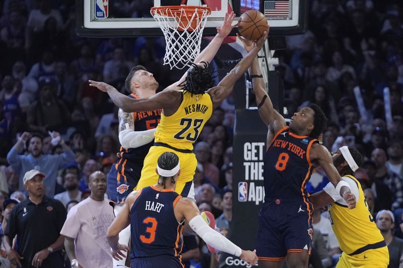 New York Knicks' OG Anunoby (8) and Isaiah Hartenstein (55) defend against a shot by Indiana Pacers' Aaron Nesmith (23) during the second half of Game 2 in an NBA basketball second-round playoff series Wednesday, May 8, 2024, in New York. The Knicks won 130-121. (AP Photo/Frank Franklin II)