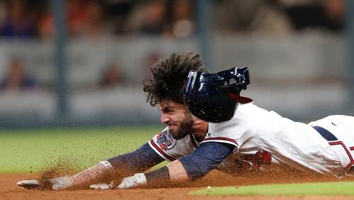 Atlanta Braves' Dansby Swanson (7) dives in to second base with a double in the ninth inning of a baseball game against the New York Mets Friday, June 9, 2017, in Atlanta. Swanson scored the winning run later in the inning to give Atlanta 3-2 victory. (AP Photo/John Bazemore)