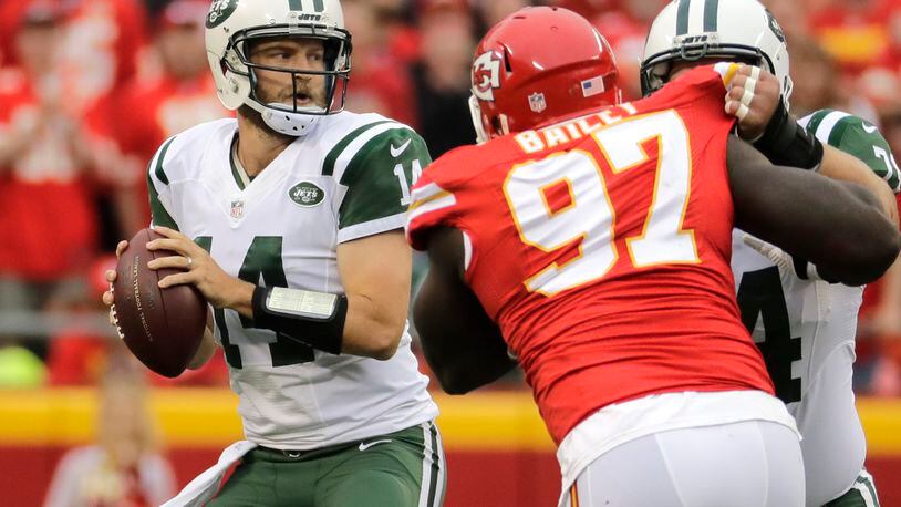 New York Jets quarterback Ryan Fitzpatrick (14) prepares to throw as center Nick Mangold, right, blocks Kansas City Chiefs defensive lineman Allen Bailey (97) during the first half of an NFL football game in Kansas City, Mo., Sunday, Sept. 25, 2016. (AP Photo/Charlie Riedel)