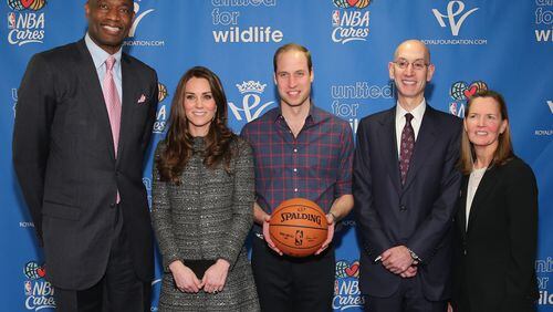 Prince William, Duke of Cambridge (C) and Catherine, Duchess of Cambridge (2nd L) pose with NBA Commissioner Adam Silver (2nd R), Global Ambassador Dikembe Mutombo (L) and Sr. Vice President, Community & Player Programs Kathleen Behrens (R) as they attend the Cleveland Cavaliers vs. Brooklyn Nets game at Barclays Center on Dec. 8, 2014, in the Brooklyn borough of New York City. (Photo by Neilson Barnard/Getty Images)