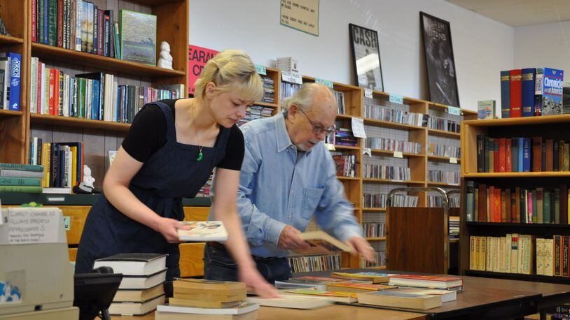 Manager Alexa Dunford and book seller Alfred “Mr. Barney” Barnhart organize books at the Marietta Book Nook. (Photo Courtesy of Stuart Hendrick)