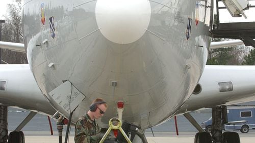 An airman uses a computer to review Electronic Technical Data used to track onboard tasks by the crew of a JSTARS surveillance plane behind him on the tarmac at Warner Robins Air Force Base in this photo from March 2003. Congress and the Pentagon have big plans in the years ahead for replacing this aging but popular fleet of 16 planes, which are based exclusively at Robins and have been in use by the Air Force for roughly 25 years. But it would have to get through a congressional budget process snarled in partisan politics. (Kimberly Smith/AJC staff)