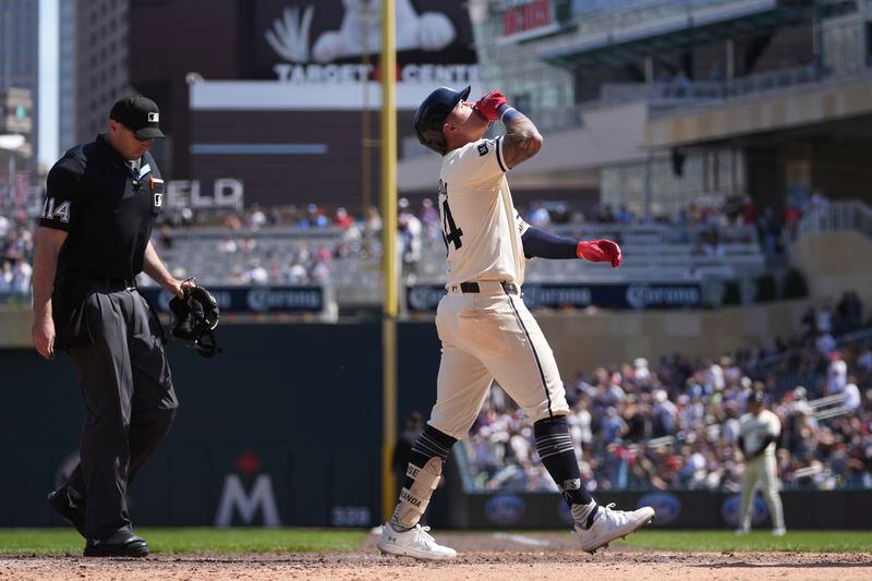 Minnesota Twins' Jose Miranda crosses home plate after hitting a solo home run during the eighth inning of a baseball game against the Chicago White Sox, Thursday, April 25, 2024, in Minneapolis. (AP Photo/Abbie Parr)