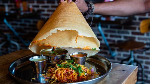 The Bollywood Masti at Indian street food restaurant Masti includes a hat-shaped dosa served over butter chicken, tomato stew and tow chutneys for dipping. CONTRIBUTED BY HENRI HOLLIS