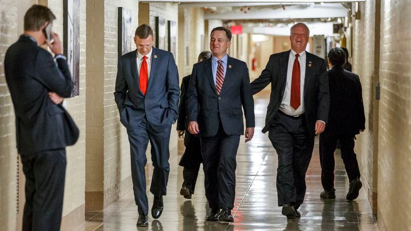 From left, Rep. Doug Collins, R-Ga., Rep. Luke Messer, R-Ind., and Rep. Paul Broun, R-Ga., and other House Republicans walk through a basement corridor at the U.S. Capitol in Washington on the way to a GOP caucus meeting, Wednesday, Dec. 10, 2014, as the 113th Congress comes to an end. With time running short before Congress adjourns, Republicans and Democrats agreed Tuesday on a $1.1 trillion spending bill to avoid a government shutdown and delay a politically-charged struggle over President Barack Obama's new immigration policy until the new year. (AP Photo/J. Scott Applewhite)