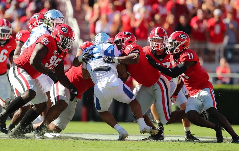 Georgia defenders smother Kentucky running back Chris Rodriguez Jr. to bring up third down and 16 years during the first quarter Saturday, Oct. 16, 2021, at Sanford Stadium in Athens. (Curtis Compton / Curtis.Compton@ajc.com)