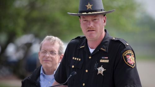 Pike County Sheriff Charles Reader speaks to the media alongside Ohio State Attorney General Mike DeWine during a news conference, Wednesday, April 27, 2016, in Waverly, Ohio. A coroner’s report released Tuesday showed new details of vicious violence in the shooting deaths of eight members of a rural southern Ohio family, finding most victims were shot three to nine times each and some of them were bruised. Meanwhile, the hunt for whoever is responsible continued to expand, with more than 200 law enforcement officials involved. (AP Photo/John Minchillo)