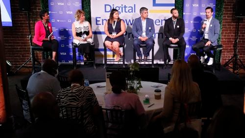 A group of panelists speaks to guests during the Visa Digital Empower Program event in downtown Atlanta on Tuesday, June 28, 2022. The program will provide 1,000 laptops to individuals and small businesses to help with digital access equity. Miguel Martinez / Miguel.martinezjimenez@ajc.com
