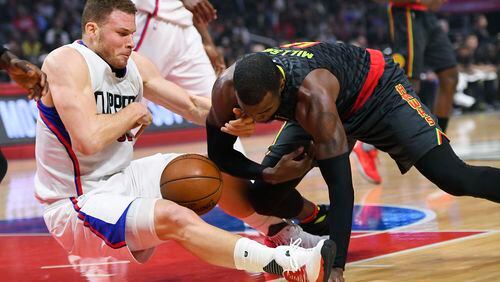 Los Angeles Clippers forward Blake Griffin, left, and Atlanta Hawks forward Paul Millsap scramble for a loose ball during the first half of an NBA basketball game, Wednesday, Feb. 15, 2017, in Los Angeles. (AP Photo/Mark J. Terrill)