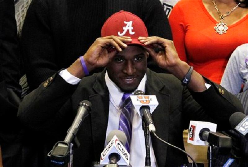 Rashaan Evans chooses Alabama as his commitment to play NCAA college football during national signing day on Wednesday, Feb. 5, 2014, in Auburn, Ala. (AP Photo/Butch Dill) If you're an Auburn fan, that's a scarlet "A." (AP photo)