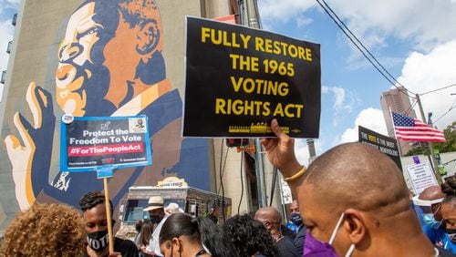 The  March On For Voting Rights march reaches the John Lewis mural on Auburn Avenue in Atlanta on Saturday, August 28, 2021.  STEVE SCHAEFER FOR THE ATLANTA JOURNAL-CONSTITUTION