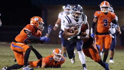 Marietta quarterback Tyler Hughes (7) is tackled by Parkview linebacker Nick Harden (6) in the second half.