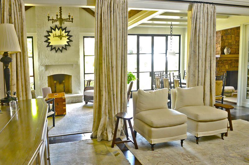 Curtains divide the living room from the sunroom in Evie Johnson's Haynes Manor home. Johnson loves the flow and beauty they give the space. Text by Lori Johnston and Shannon Adams/Fast Copy News Service.