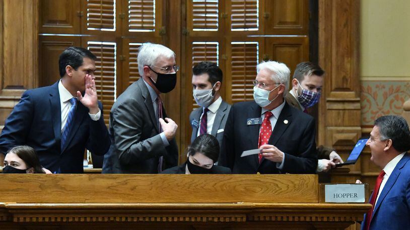 January 12, 2021 Atlanta - Lt. Gov. Geoff Duncan (left) confers with staff inside the Senate Chambers during the second day of the 2021 legislative session at the Georgia State Capitol building on Tuesday, January 12, 2021. (Hyosub Shin / Hyosub.Shin@ajc.com)