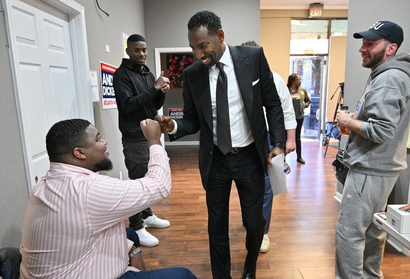 December 1, 2021 Atlanta - Mayor-elect Andre Dickens (right) exchanges fist-bumps before their staff meeting at his campaign headquarters on Wednesday, December 1, 2021. Andre Dickens, the Atlanta native who first beat an incumbent eight years ago for a spot on the City Council, defeated Felicia Moore in Tuesday’s runoff election to become Atlanta’s 61st mayor. (Hyosub Shin / Hyosub.Shin@ajc.com)