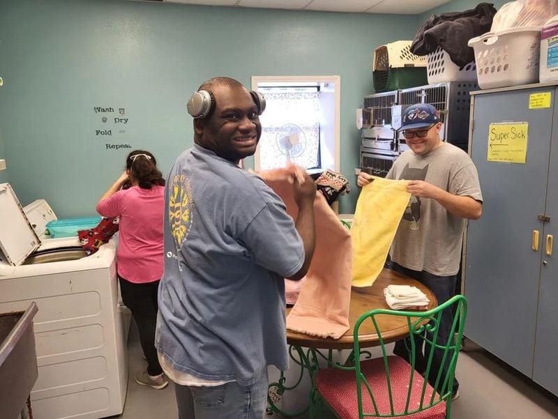 Volunteers from The Arc of Southwest Georgia fold blankets at the Best Friends Humane Society in Worth County. (Photo Courtesy of Jakin Tillery)