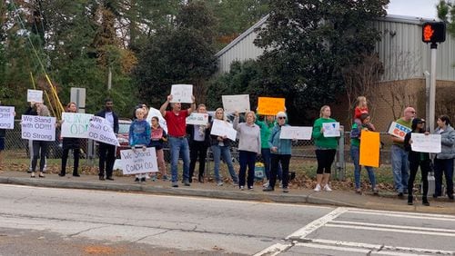 Several dozen parents and community members showed their support for suspended coach James O’Donnell Friday at Henderson Mill Elementary School.
