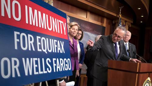 Senate Minority Leader Chuck Schumer, D-N.Y. and other Senate Democrats, from left, Sen. Al Franken, D-Minn., Sen. Elizabeth Warren, D-Mass., Sen. Catherine Cortez Masto, D-Nev., and Sen. Patrick Leahy, D-Vt., discuss consumer protections in the wake of a massive data breach at Equifax and a scandal at Wells Fargo, at the Capitol in Washington, Wednesday, Sept. 27, 2017. Executives for both Wells Fargo and Equifax will testify in Senate committees next week. (AP Photo/J. Scott Applewhite)