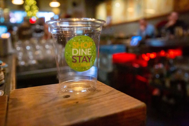 The new to-go cups sit on the bar at the Brickhouse Pub in Decatur Friday, December 10, 2021. STEVE SCHAEFER FOR THE ATLANTA JOURNAL-CONSTITUTION