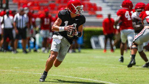 Georgia quarterback Gunner Stockton (14) rolls to the right looking for an open receiver during Georgia’s scrimmage on Dooley Field at Sanford Stadium in Athens, on Saturday, Aug. 19, 2023. (Tony Walsh/UGA Athletics)