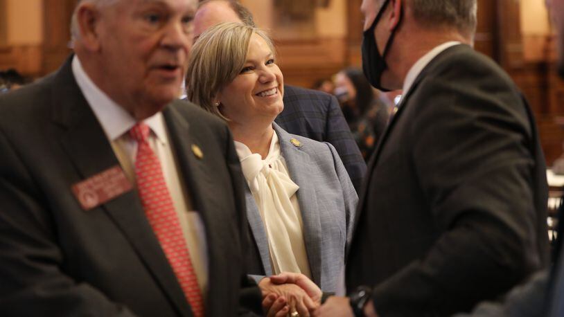 State Rep. Bonnie Rich, a co-sponsor of the redistricting bill, shakes hands after it passed Monday. Miguel Martinez for The Atlanta Journal-Constitution