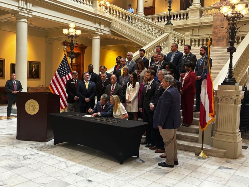 Gov. Brian Kemp signs a new package of human trafficking measures Wednesday at the Georgia Capitol. Contributed. 