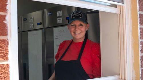 CEO and co-owner Ashley Chapman Hubbard, shown in the Tucker Brewing kitchen window on opening night, had long dreamed of adding an on-site kitchen.
Contributed by Eliana Barnard, Tucker Brewing Co.