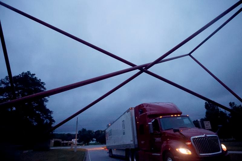 A truck driver under the “Atlanta Gateway” sculpture in Atlanta on Wednesday, June 21, 2023. (Michael Blackshire / Michael.Blackshire@ajc.com)