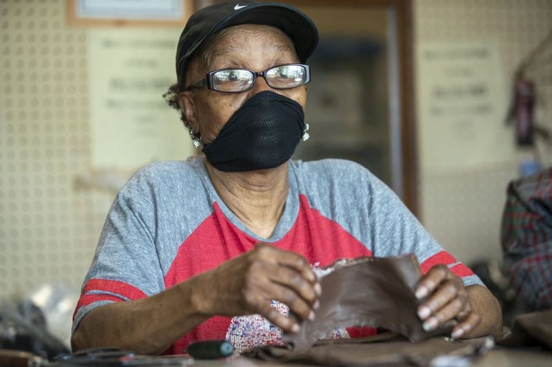 Hattie Jordan, wife of Joe Jordan, cuts loose string from a boot that her husband will repair at their shop, Cato Shoe Repair, in Atlanta. She says she was roped into working with her husband in the beginning and has been in the shop with him since the 1960s. Hattie says she’s ready to stop working while Joe says he loves the challenge of fixing items. (ALYSSA POINTER / ALYSSA.POINTER@AJC.COM)