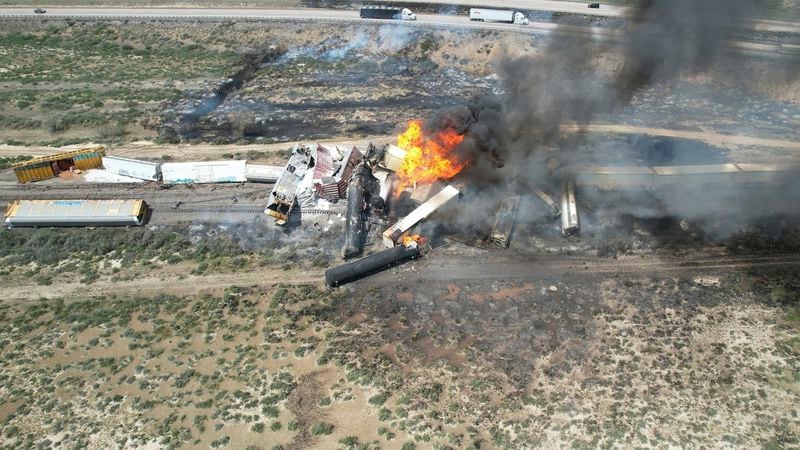 In this photo provided by David Yellowhorse, a freight train carrying fuel derailed and caught fire, Friday, April 26, 2024, east of Lupton, Ariz., near the New Mexico-Arizona state line. Authorities closed Interstate 40 in both directions in the area, directing trucks and motorists to alternate routes. (David Yellowhorse via AP)