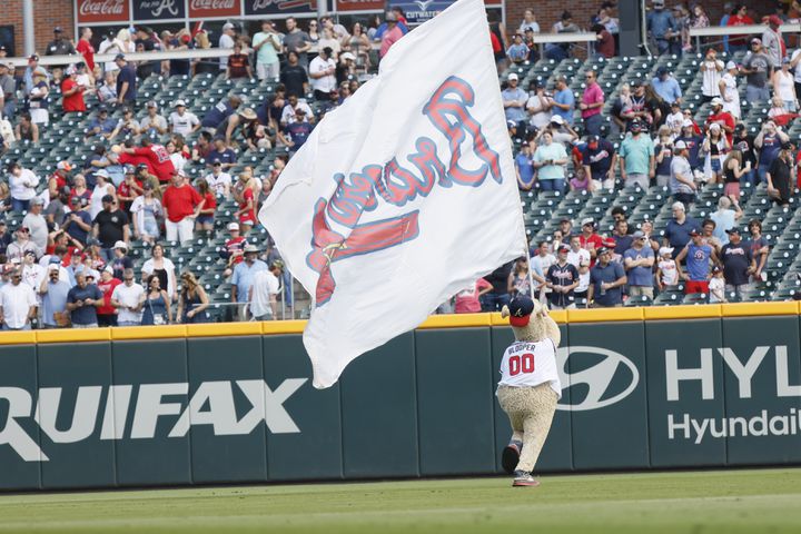 Braves mascot Blooper waves a flag after the team completed a three-game sweep against the rival Phillies on Sunday at Truist Park. (Miguel Martinez / miguel.martinezjimenez@ajc.com)