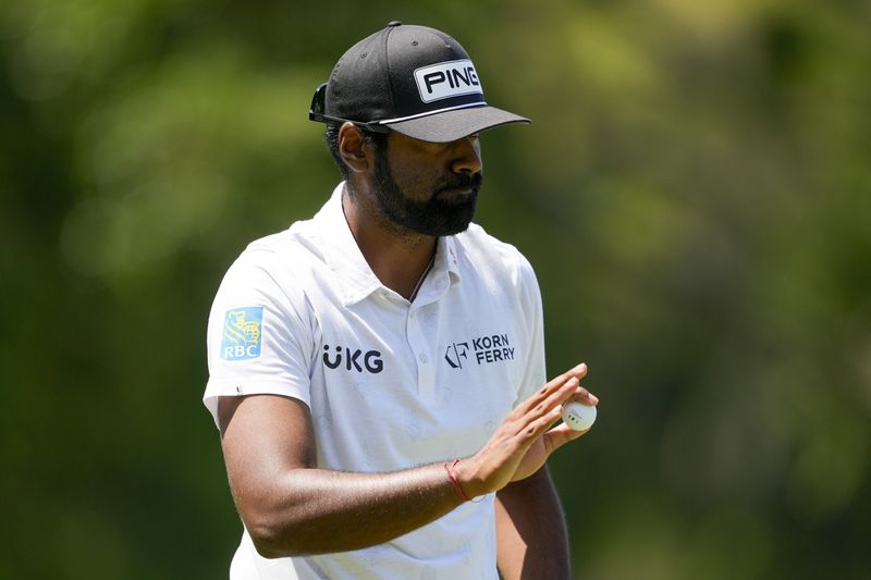 Sahith Theegala waves after making a putt on the fifth hole during the first round of the RBC Heritage golf tournament, Thursday, April 18, 2024, in Hilton Head, S.C. (AP Photo/Chris Carlson)