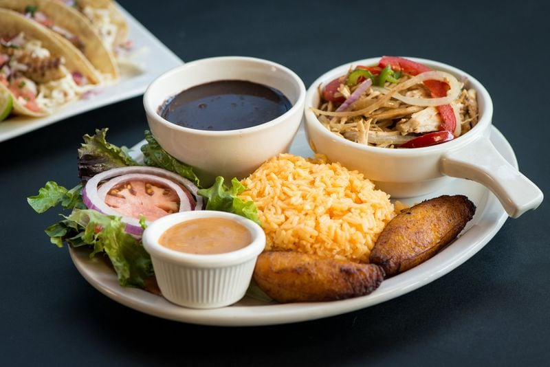 The pollo vaca frita at Papi’s Cuban Grill features shredded chicken, peppers, yellow rice, black beans, salad and plantains. CONTRIBUTED BY MIA YAKEL