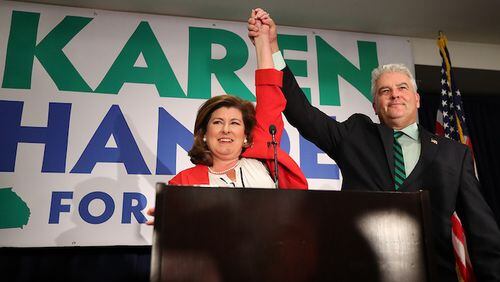 Republican candidate Karen Handel and her husband, Steve, take the podium for her victory speech at her election night party in the 6th District race with Democrat Jon Ossoff on Tuesday, June 20, 2017, in Atlanta. (Curtis Compton/Atlanta Journal-Constitution/TNS)