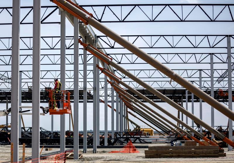 Workers erect a large steel frame building on the Hyundai Metaplant site, Monday, July 5, 2023, in Ellabell, Ga. (Stephen B. Morton for the Atlanta Journal-Constitution)