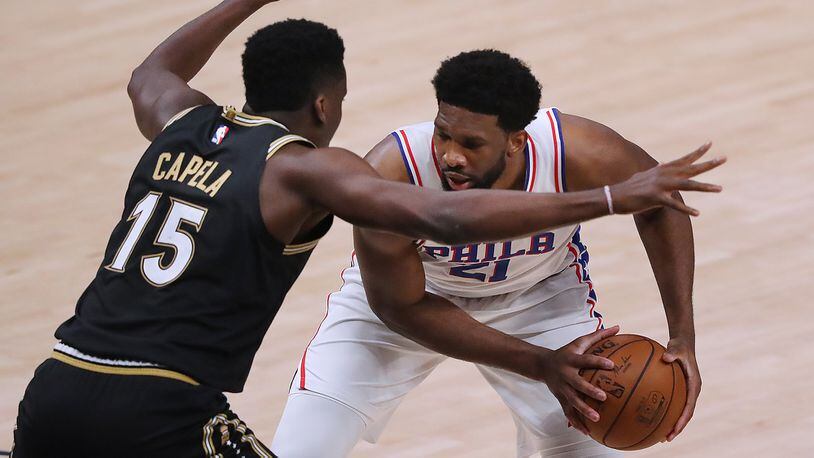 Big man battle at State Farm Arena: Hawks center Clint Capela squares up to defend 76ers center Joel Embiid during Monday's Game 4 of the Eastern Conference semifinals in Atlanta.