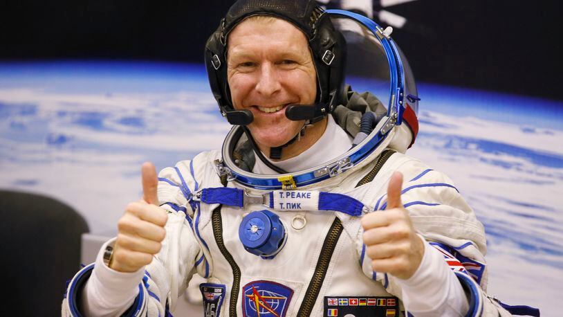 FILE - In this Tuesday, Dec. 15, 2015 file photo, British astronaut Tim Peake, member of the main crew of the expedition to the International Space Station (ISS), gestures prior the launch of Soyuz TMA-19M space ship at the Russian leased Baikonur cosmodrome, Kazakhstan. Anyone can dial a wrong number, but it’s not often done from outer space. Peake tweeted an apology on Christmas Day from the International Space Station after calling a wrong number. (AP Photo/Dmitry Lovetsky, File)