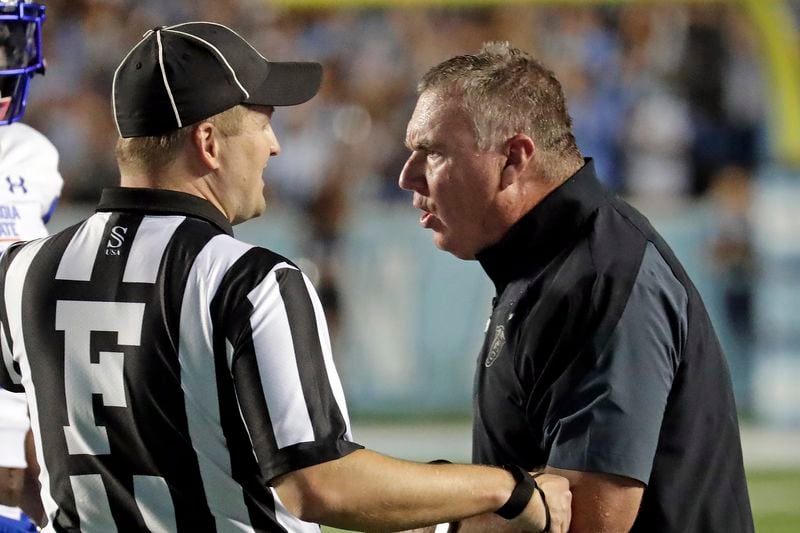 Georgia State head coach Shawn Elliott confers with an official during the first half of an NCAA college football game against North Carolina in Chapel Hill, N.C., Saturday, Sept. 11, 2021. (AP Photo/Chris Seward)