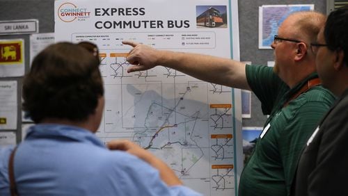 April 25, 2018 Lawrenceville: Jessica & Derek Behmke, Lawrenceville, look over one of the displays during a Gwinnett County public open house and information session on it's proposed transit plan at the Gwinnett Justice and Administrative Center on Tuesday, April 25, 2018, in Lawrenceville.  Curtis Compton/ccompton@ajc.com