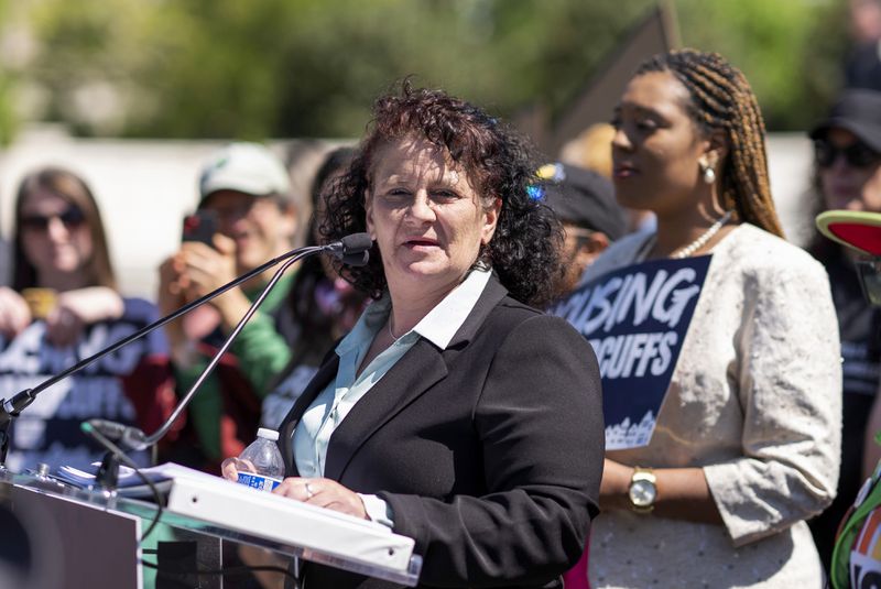 Helen Cruz, who once lived on the streets in Grants Pass, Ore., speaks at a rally outside the Supreme Court as the justices hear arguments in the Grants Pass homeless case, on Capitol Hill in Washington, Monday, April 22, 2024. (AP Photo/J. Scott Applewhite)