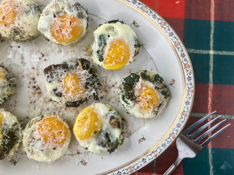 Baked eggs with spinach and mushrooms topped with Parmesan cheese and red pepper flakes accommodates vegetarian and gluten-free diets.
(Virginia Willis for The Atlanta Journal-Constitution)