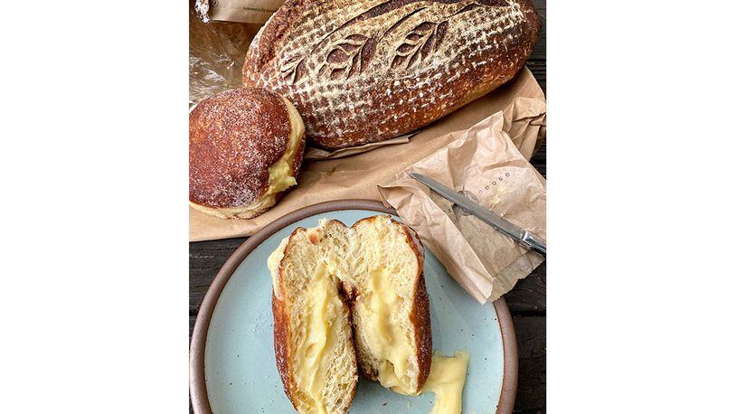 From Osono Bread, a loaf of country sour bread and two filled doughnuts, including the horchata (on the plate) and the cardamom (by the loaf).
Wendell Brock for The Atlanta Journal-Constitution