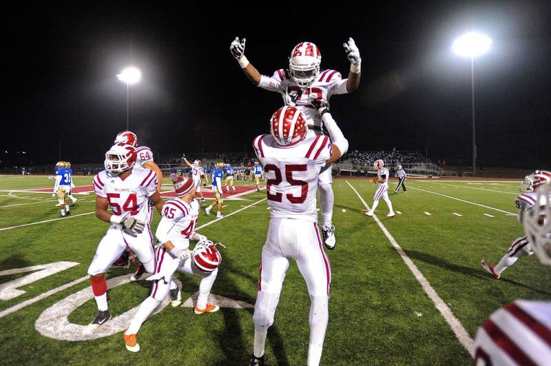 Hillgrove's Richardre Bagley (23) is hoisted high by Bradley Chubb to celebrate their 31-17 win over McEachern at Cobb Energy Field on Friday, Nov. 8, 2013, in Powder Springs, Ga.
